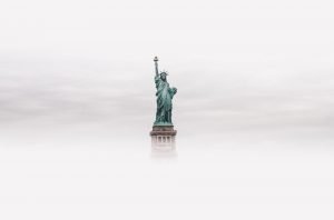 statue of liberty through clouds