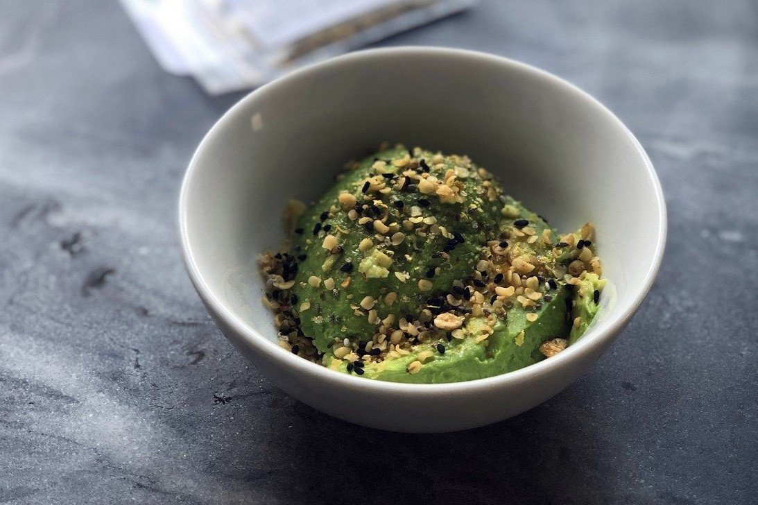 avocado in a bowl with hemp seeds